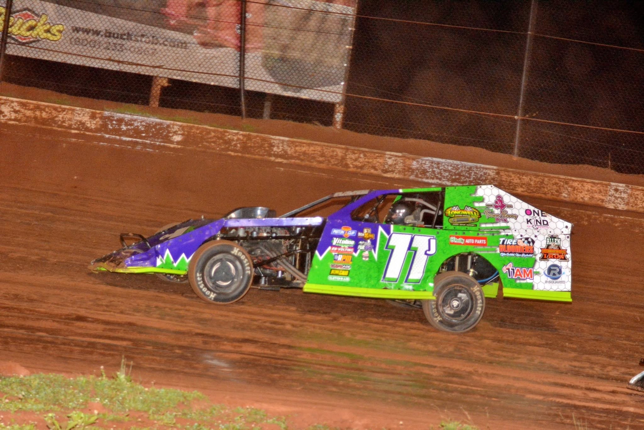 Ryan Johnston's #11J car racing on a dirt track